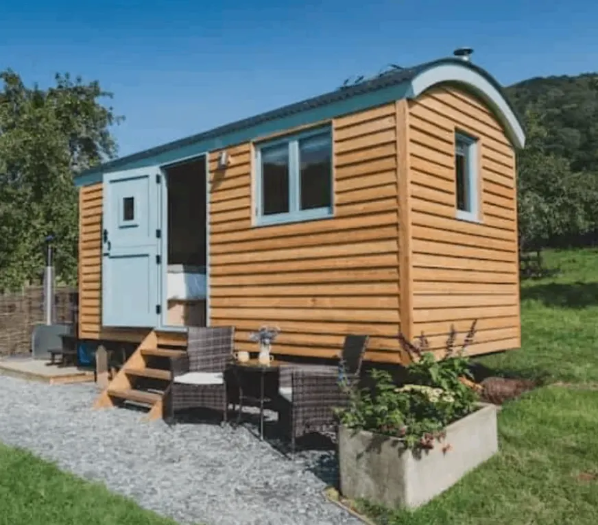 Timber-clad garden glamping pod with an outdoor deck