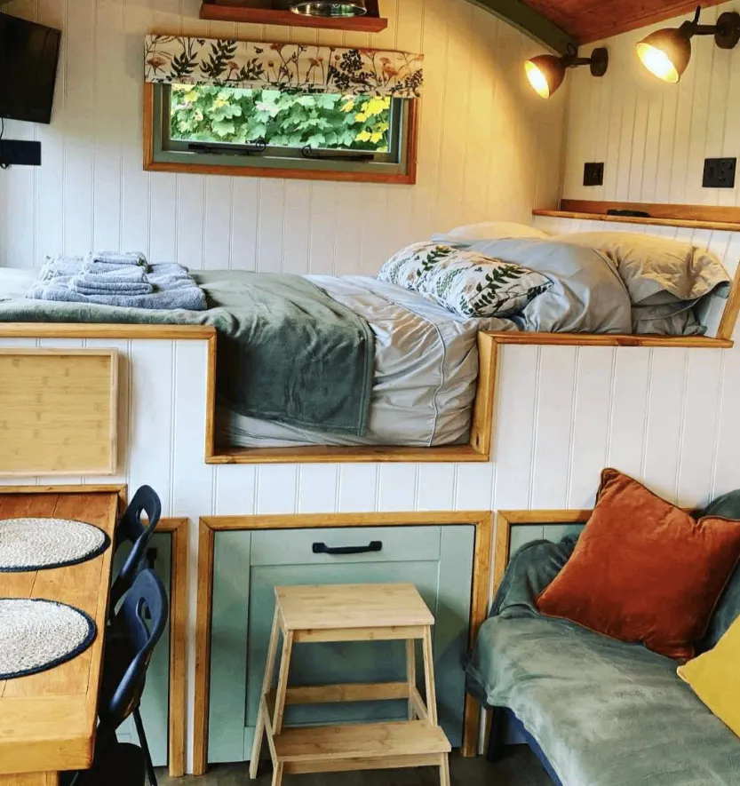 Fitted timber bedroom furniture in a glamping pod