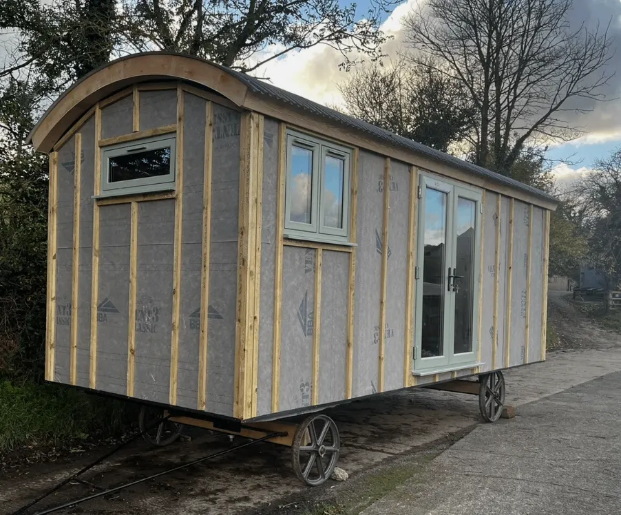 Curved roof timber frame during a shepherd hut build