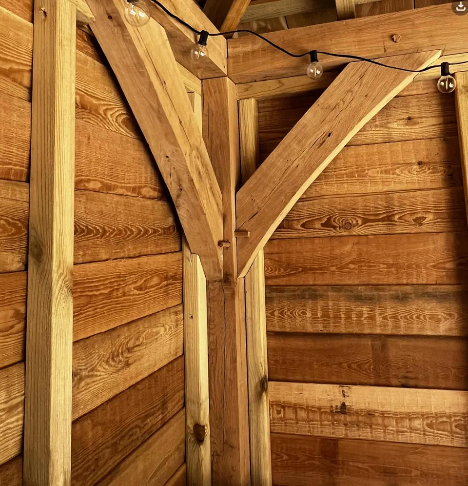 Oak post and bracing with visible natural grain and carefully fitted joints
